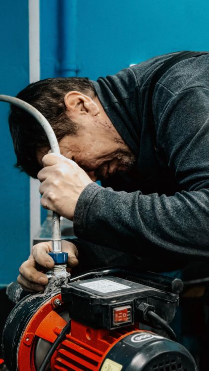 plumbing technician repairing water pipe professional