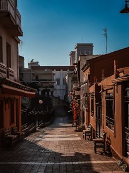Explore the vibrant architecture of a quiet street in Patras, Greece.