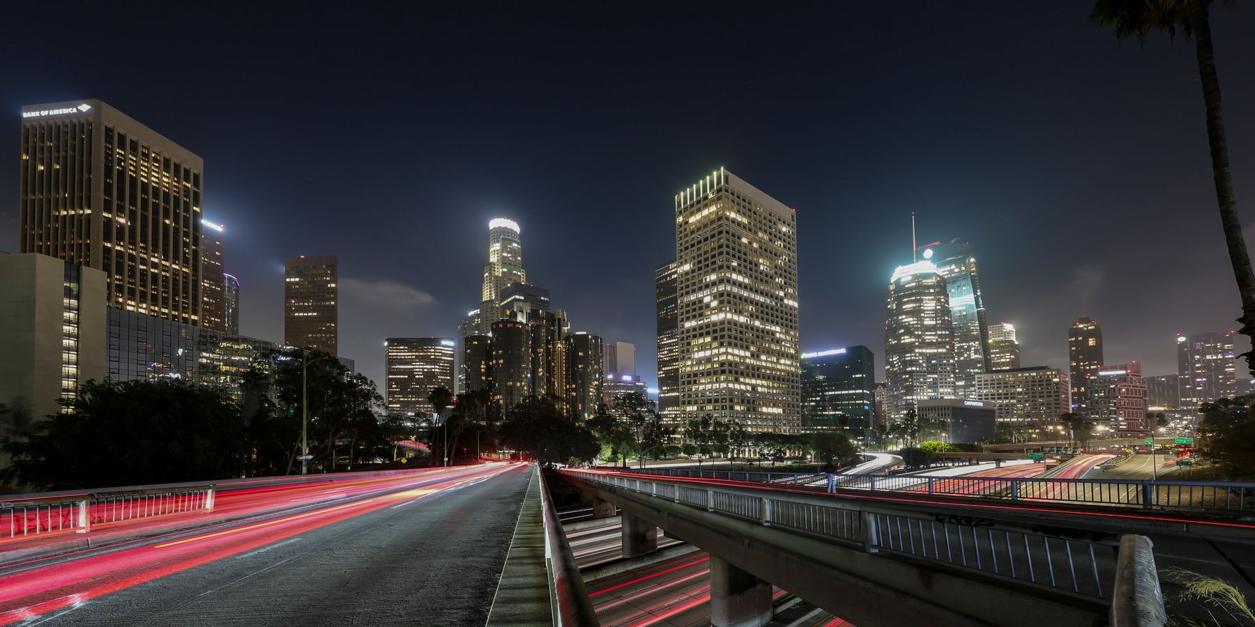 Vibrant long exposure of Downtown Los Angeles skyscrapers at night, showcasing the city skyline.