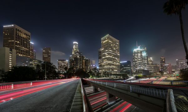 Vibrant long exposure of Downtown Los Angeles skyscrapers at night, showcasing the city skyline.