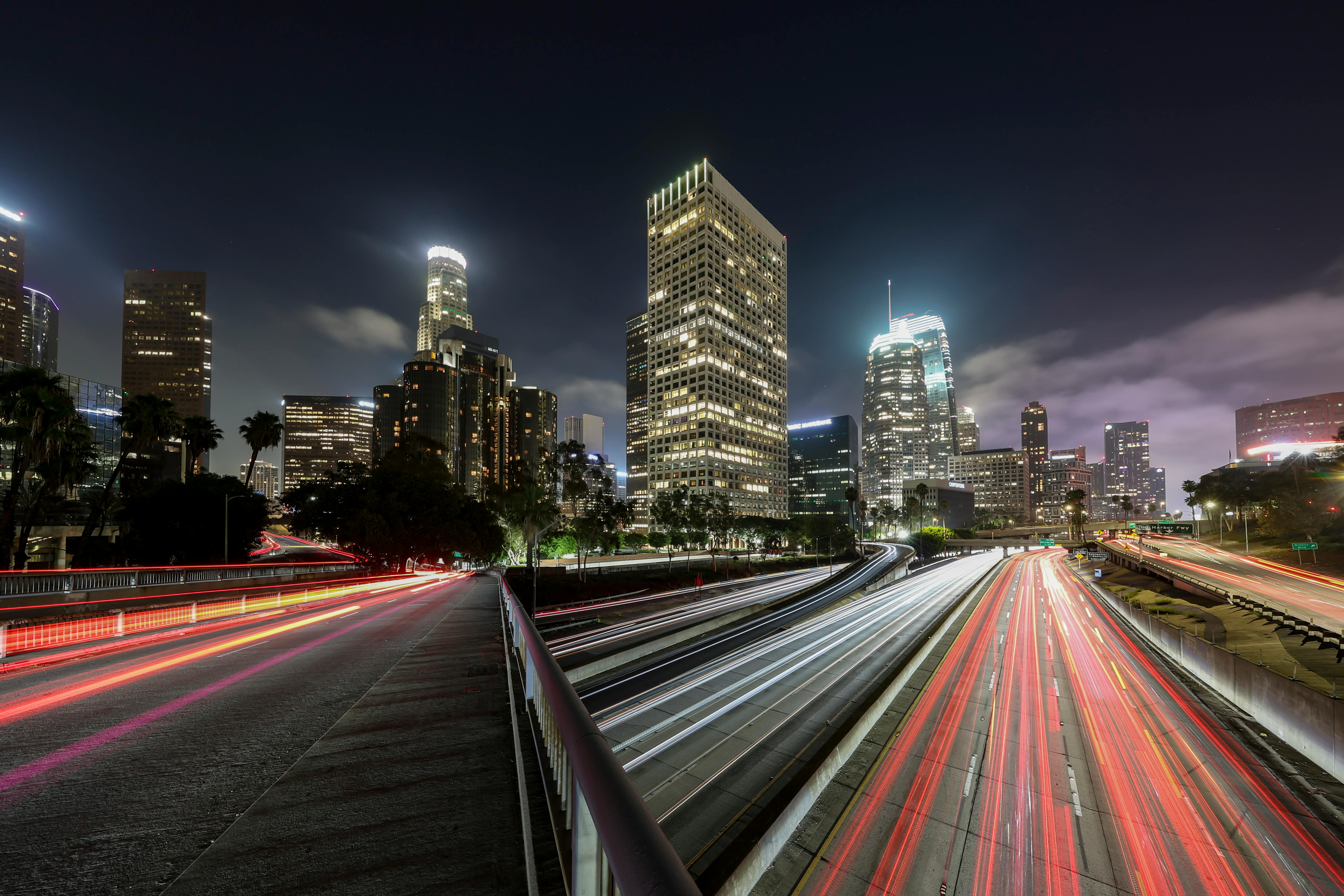 Stunning long exposure of Los Angeles skyline with light trails and skyscrapers at night.