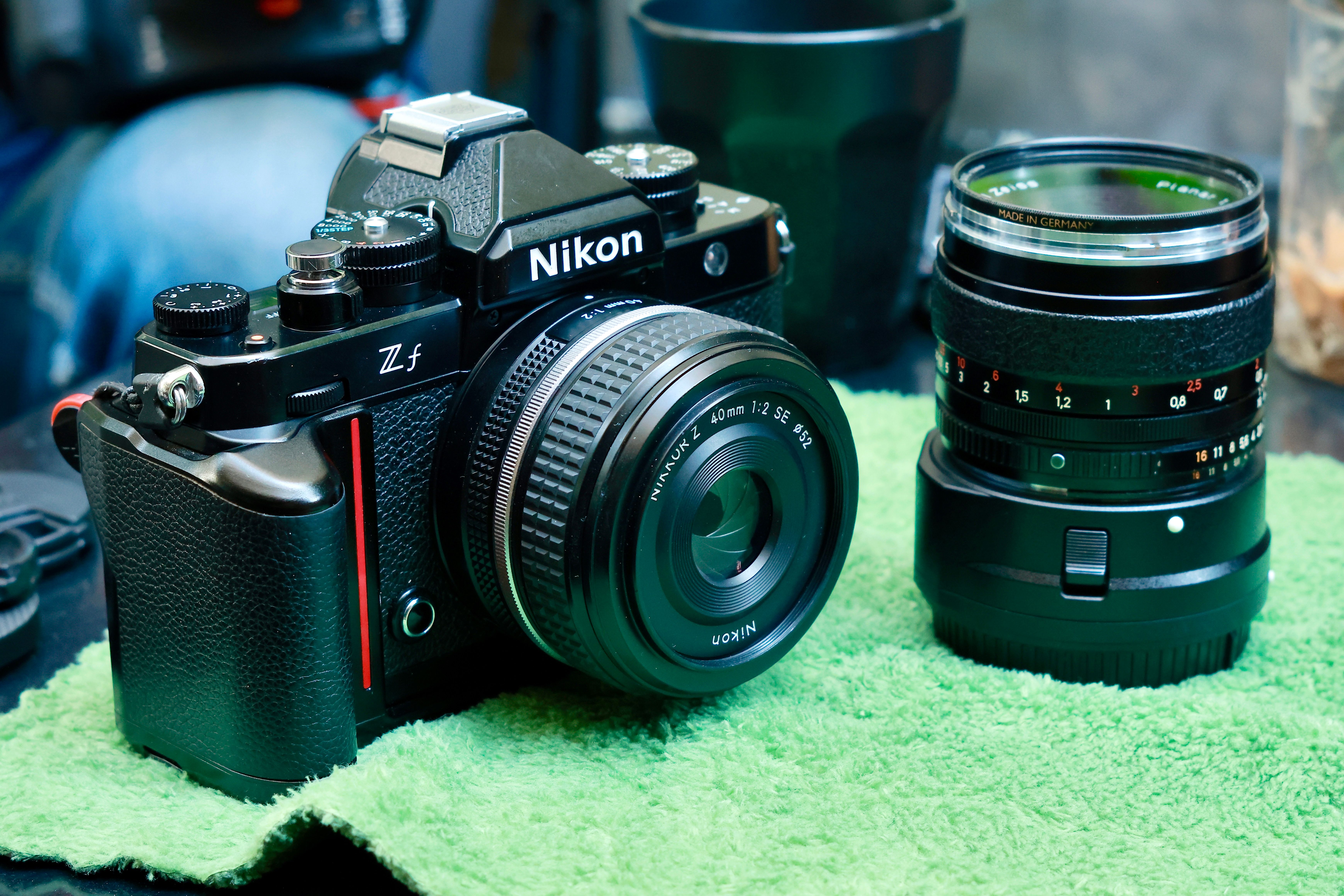 Nikon camera and lens on green cloth, perfect for photography enthusiasts.