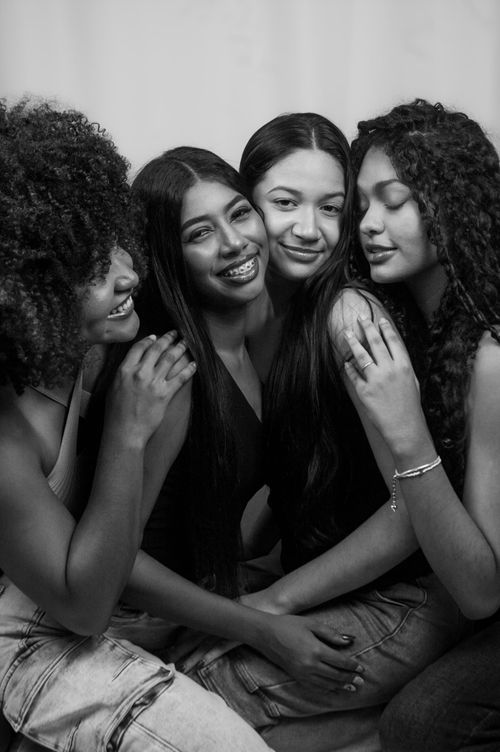 Free Embracing friendship and diversity through a black and white portrait of four young women. Stock Photo
