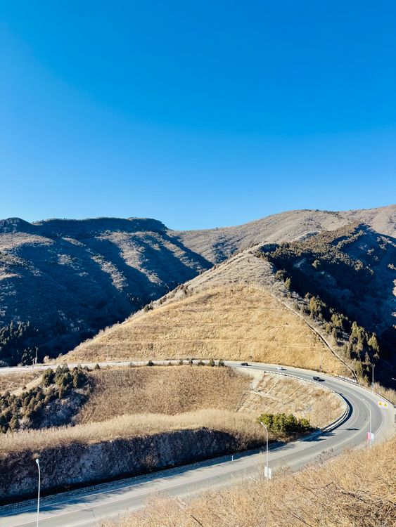 Scenic Mountain Road with Clear Blue Sky · Free Stock Photo