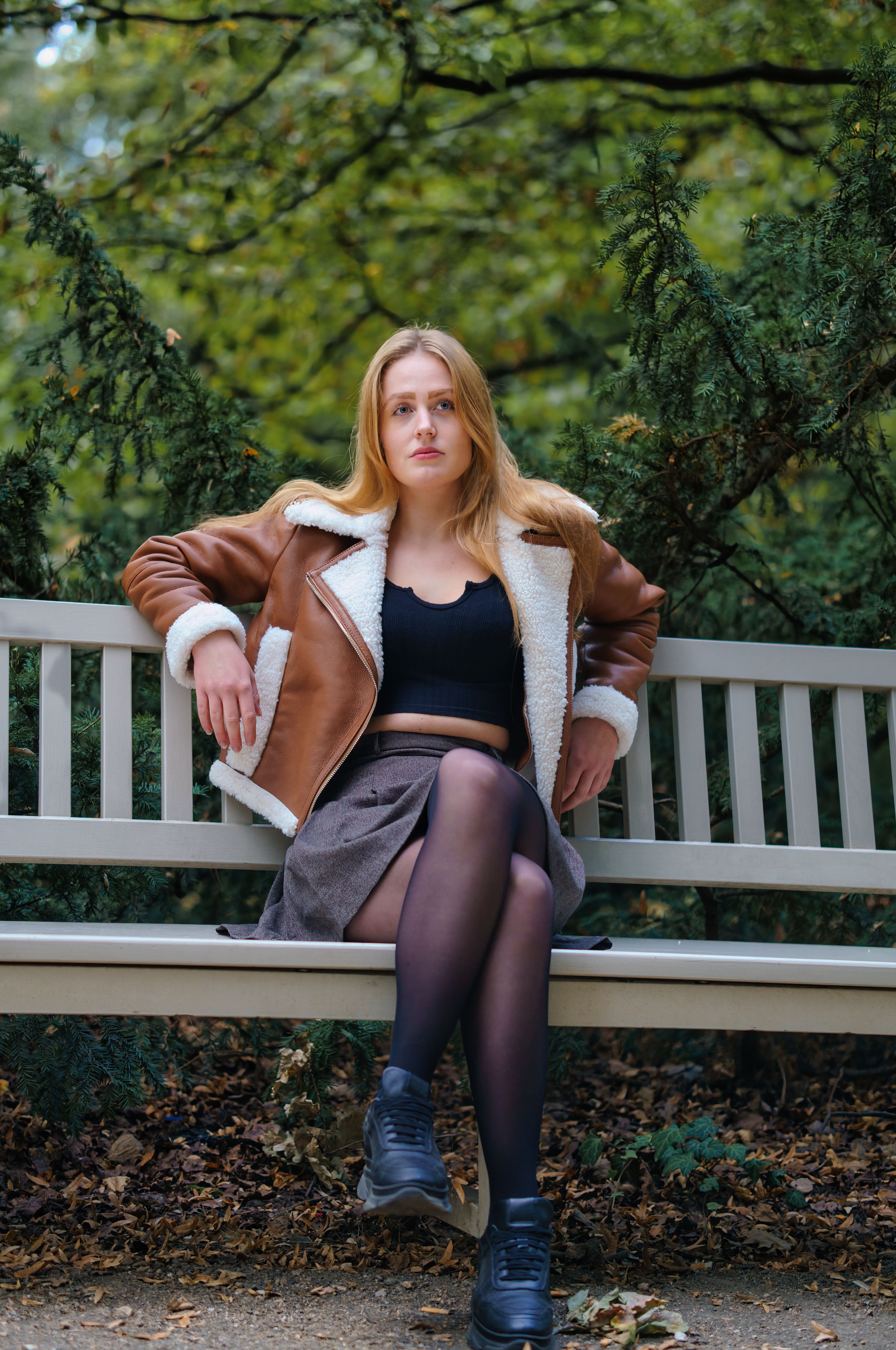 Young Woman Relaxing on Park Bench in Autumn · Free Stock Photo