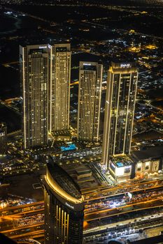 A breathtaking aerial view of Dubai's illuminated skyscrapers at night.