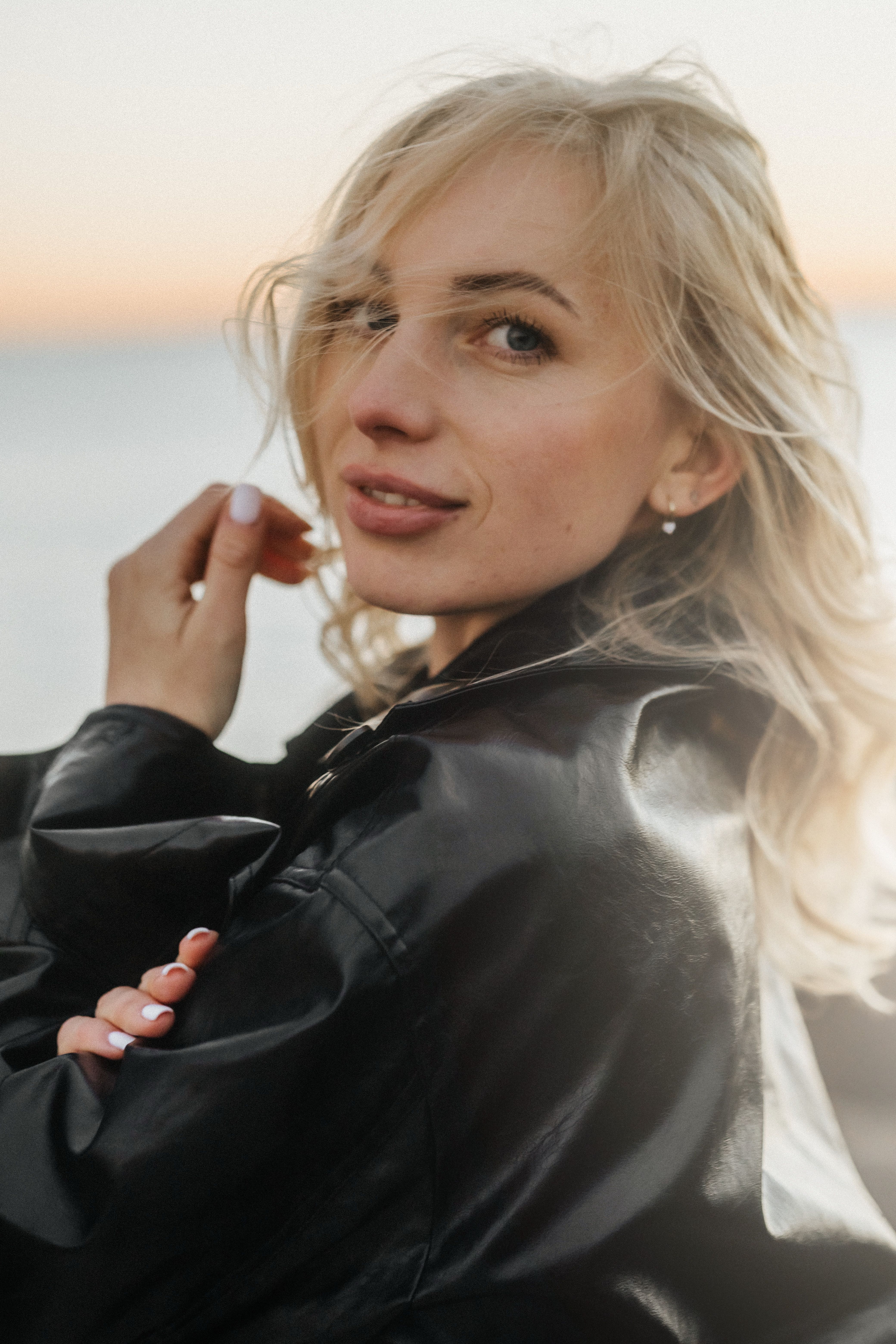 Stylish Woman Posing Outdoors at Sunset · Free Stock Photo
