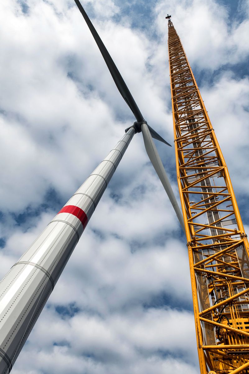 Close-up of a wind turbine and crane symbolizing renewable energy