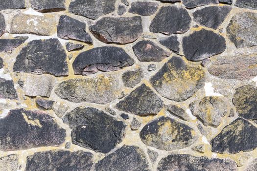 Close-up of an ancient stone masonry wall showcasing natural rock textures and patterns.