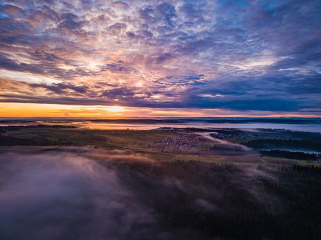 A breathtaking aerial sunrise over a misty countryside landscape in BW, Germany.