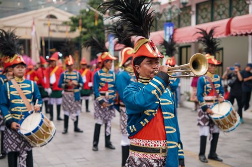 Free Colorful parade featuring traditional costumes and musical performances in Yogyakarta, Indonesia. Stock Photo