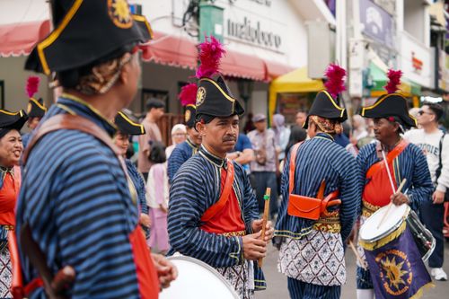 Free Participants in traditional attire during a cultural parade in Yogyakarta, showcasing vibrant costumes and musical instruments. Stock Photo