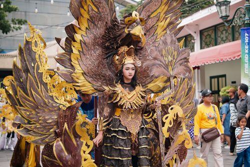 Free Participants in elaborate costumes parade during a cultural festival in Yogyakarta, Indonesia. Stock Photo