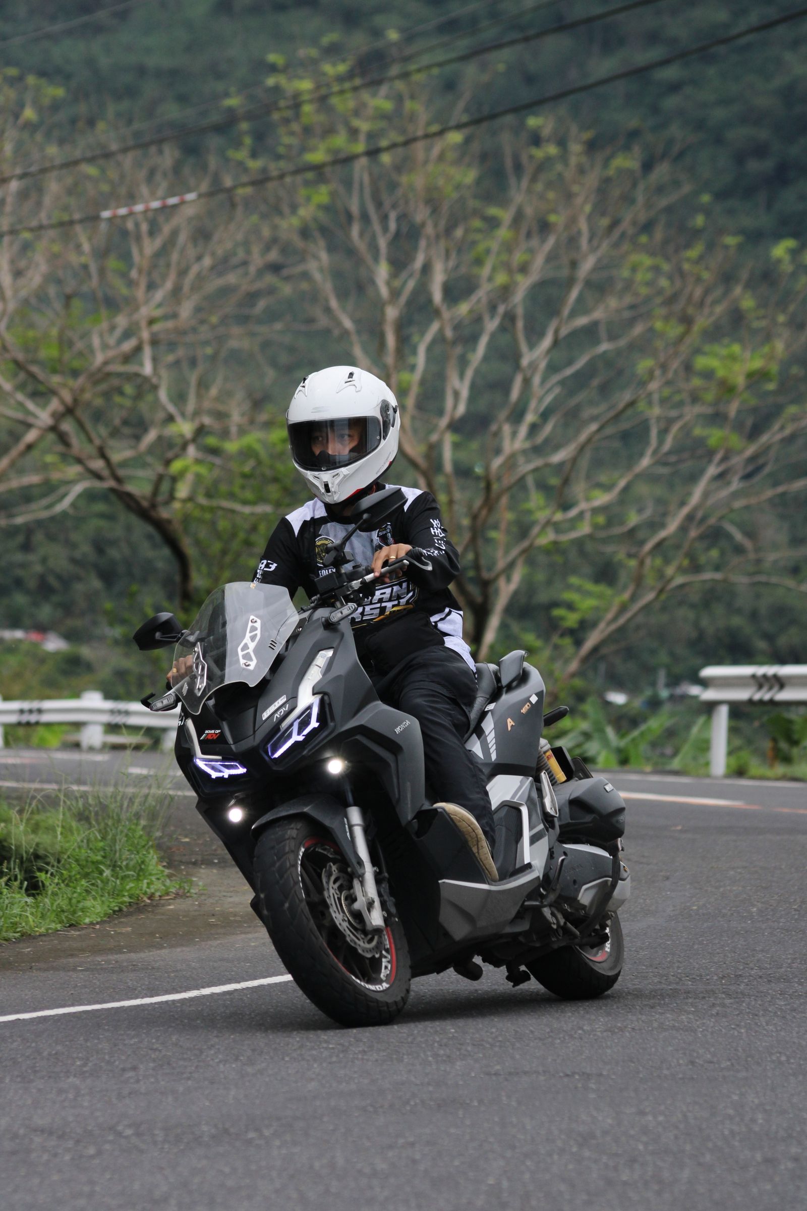 Motorcyclist riding on a scenic mountain road showing how to choose a good Ha Giang tour before booking
