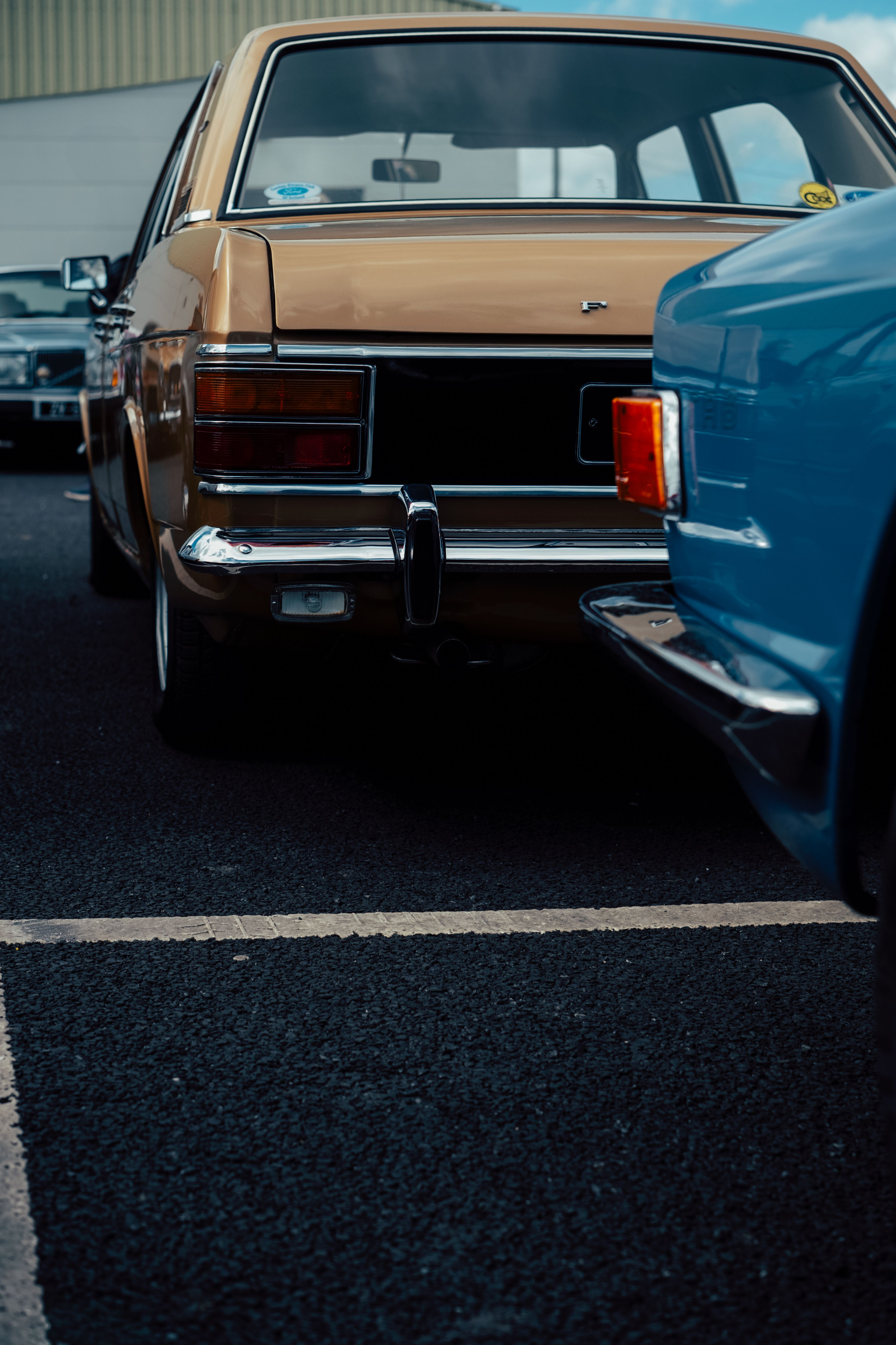 Vintage brown car parked on asphalt, highlighting its classic 1970s design and chrome details.