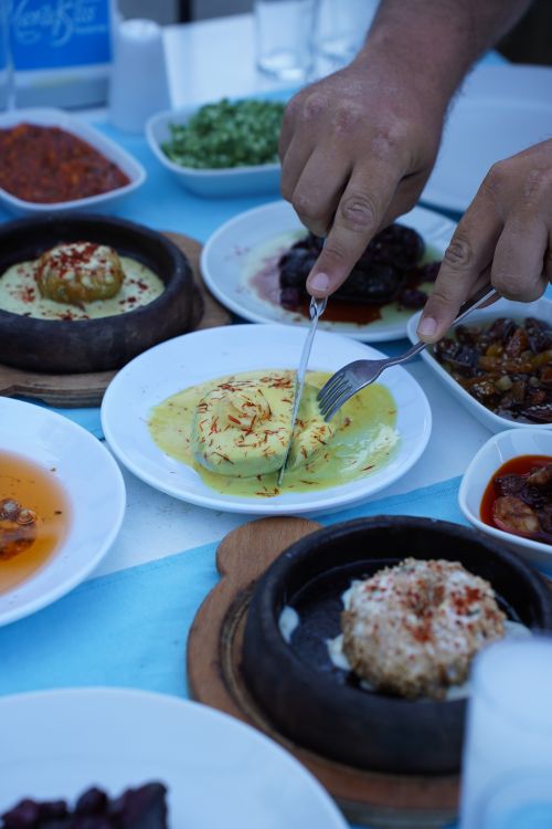 Free An inviting spread of Turkish meze dishes at an outdoor tavern in Çanakkale, showcasing vibrant colors and rich textures. Stock Photo