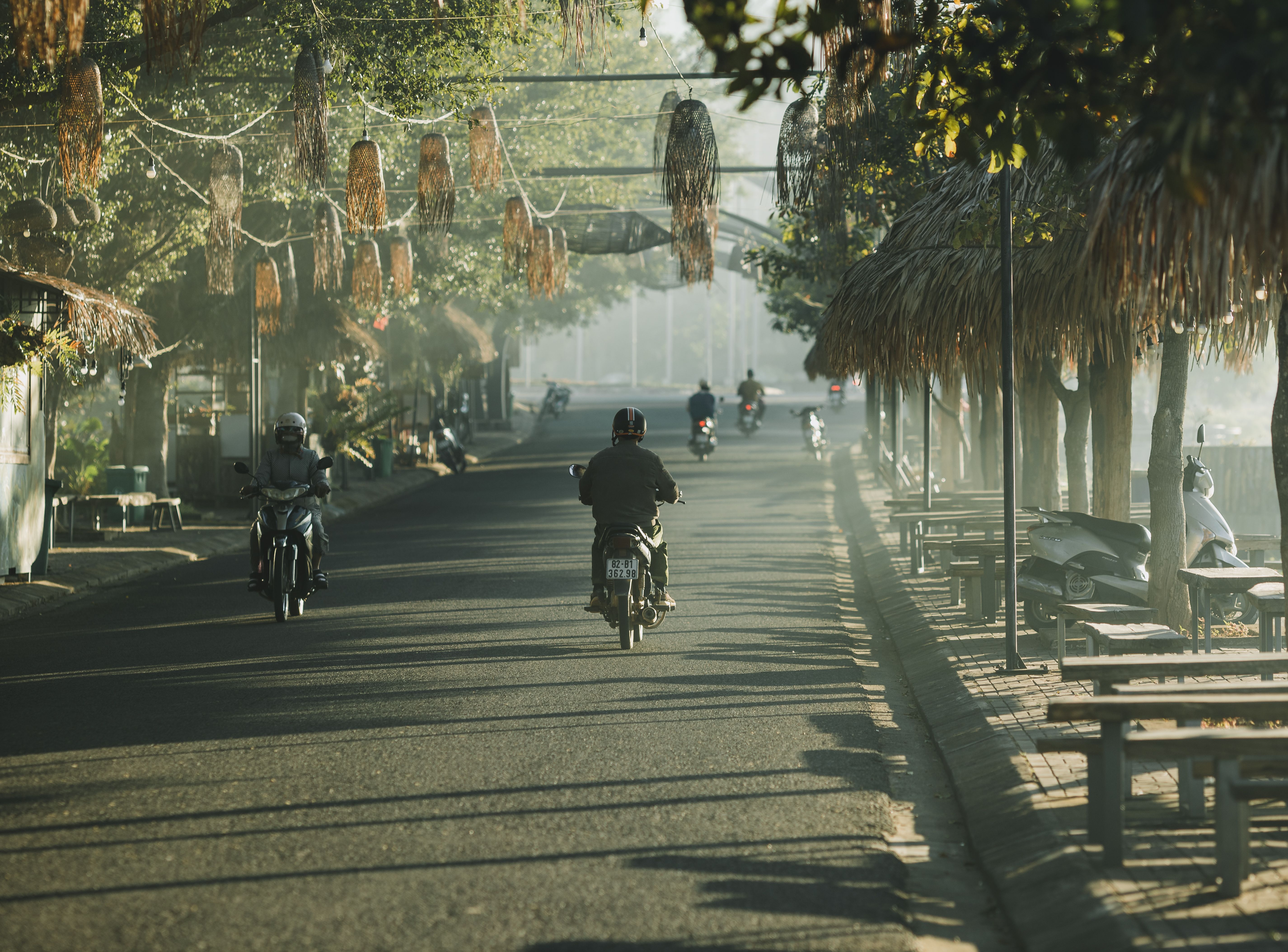 person holding smartphone navigating a quiet street in Hoi An, early morning