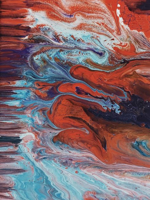 Bold, colorful abstract art with swirling patterns in vivid red and blue hues.