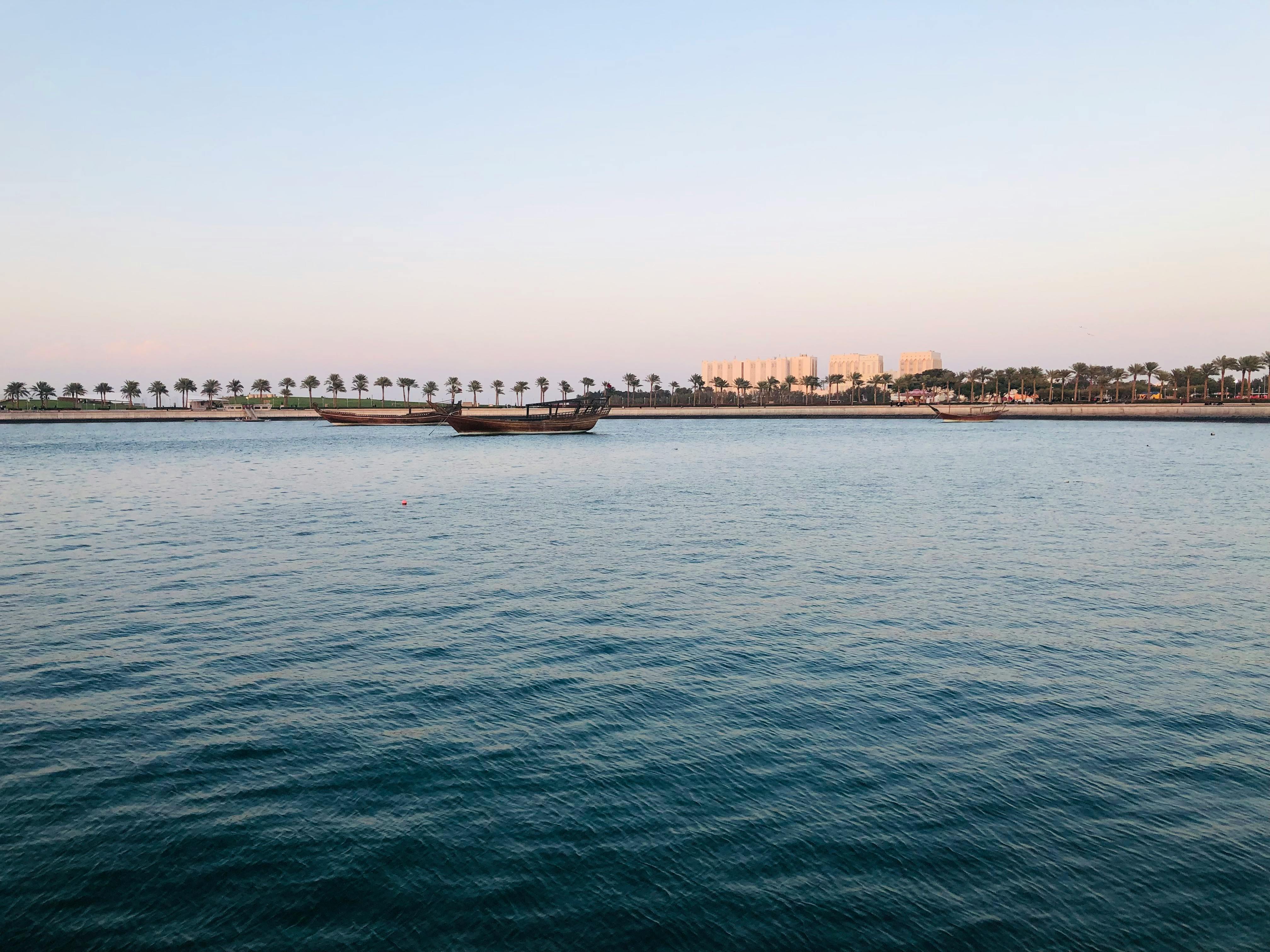 Persian Gulf coastline with calm sea at dusk.