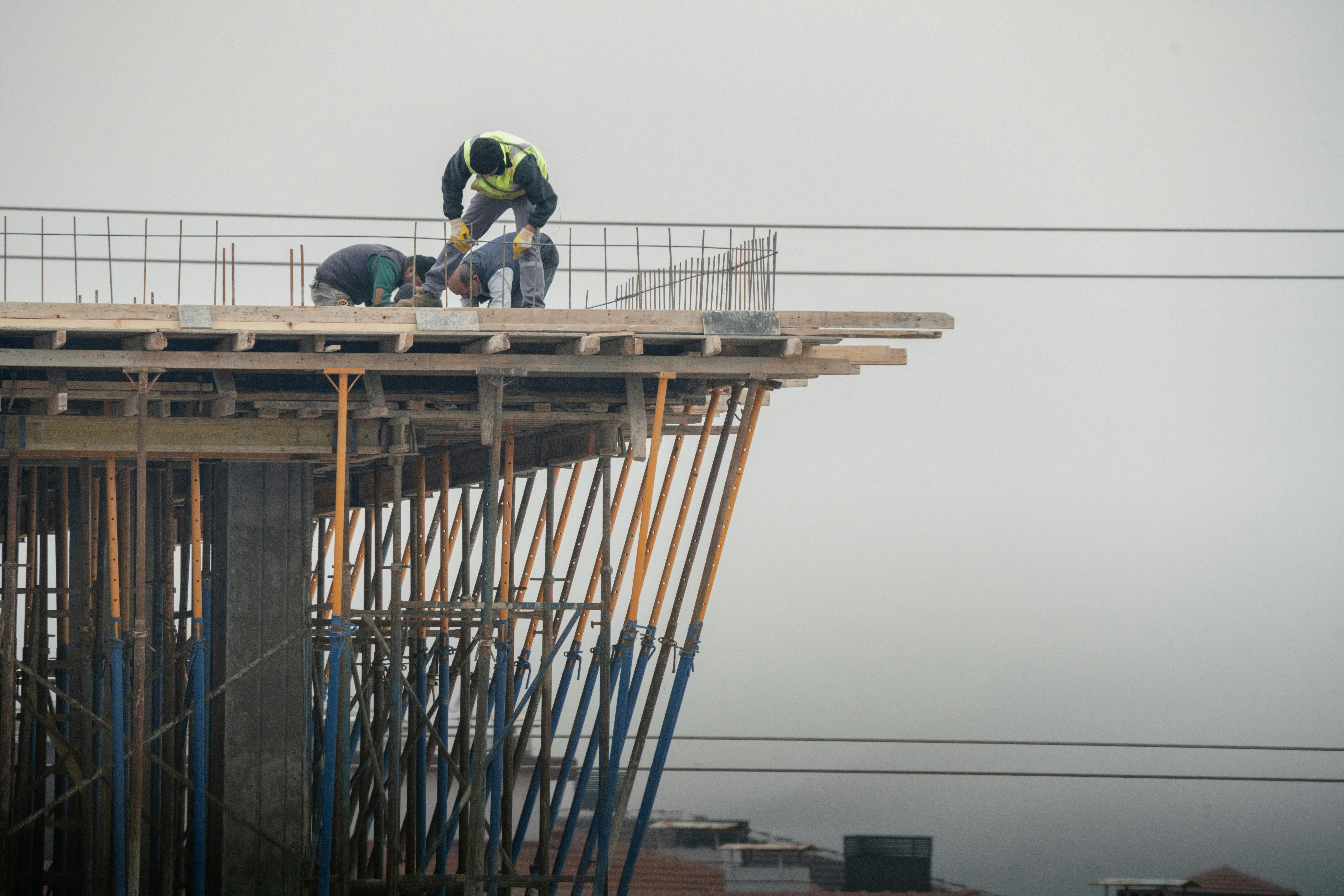 Workers on a high-rise building construction site in Denizli, Türkiye, showcasing teamwork and safety.