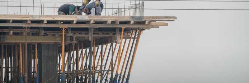 Workers on a high-rise building construction site in Denizli, Türkiye, showcasing teamwork and safety.