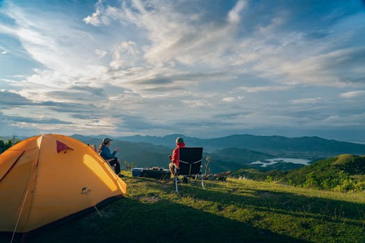 Two people enjoy a serene sunrise camping in the mountains of Quảng Ninh, Vietnam.