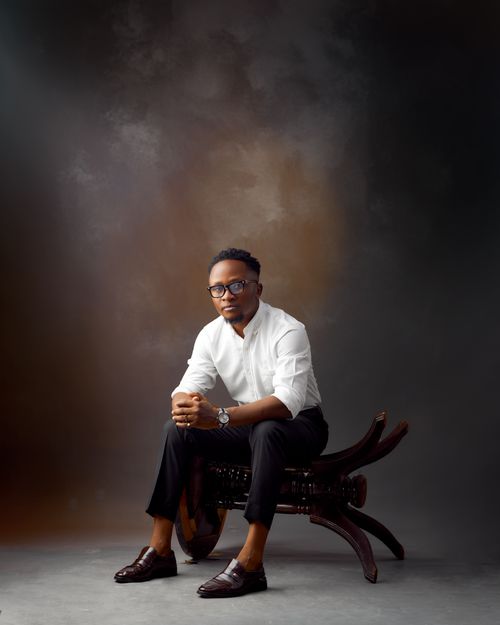 Free Professional portrait of a stylish man in white shirt and glasses seated in studio. Stock Photo