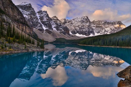 Explore the serene beauty of Moraine Lake with its crystal-clear reflections and majestic Rocky Mountains.