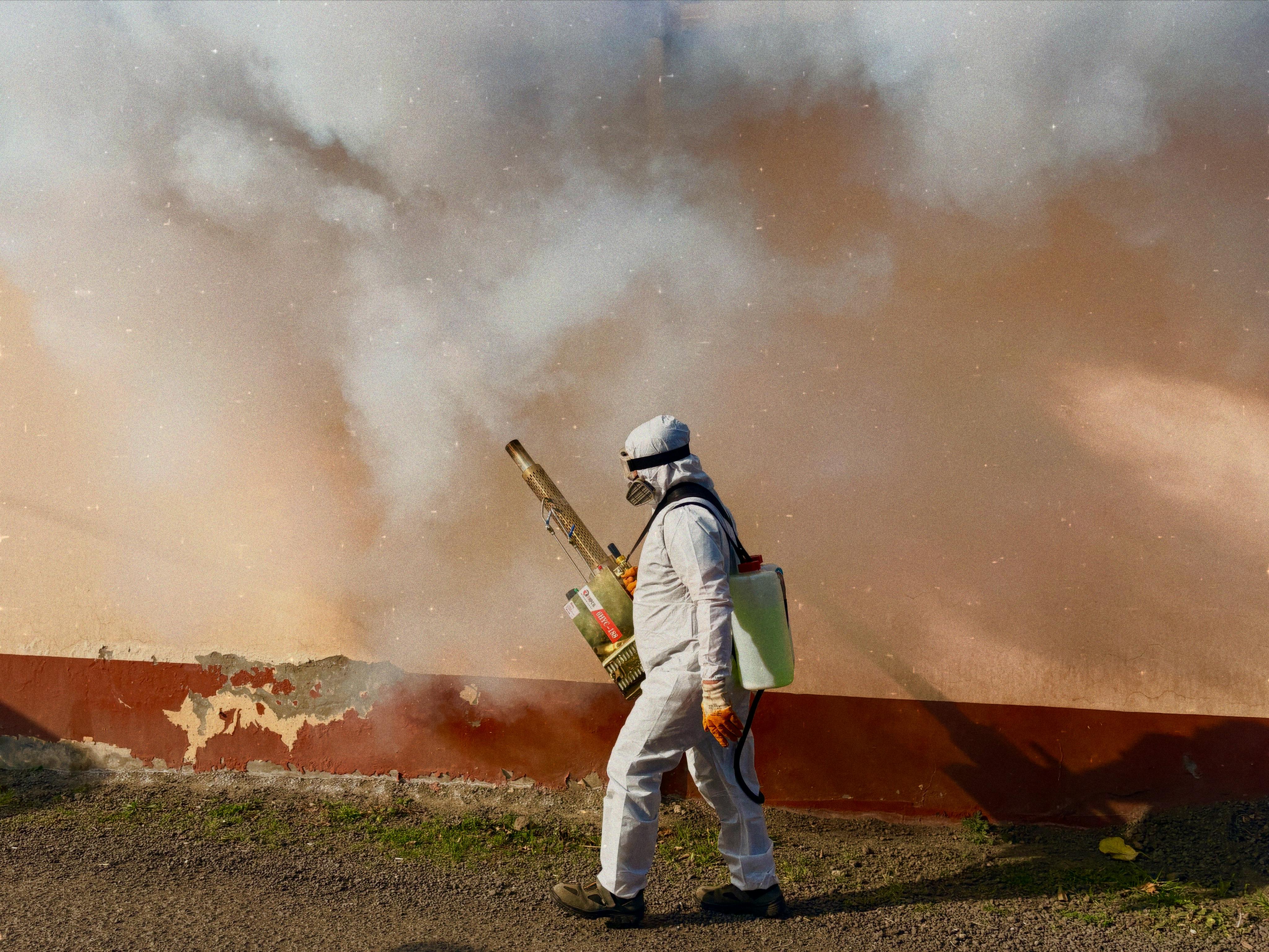 Technician applying a safe pest control treatment inside a home