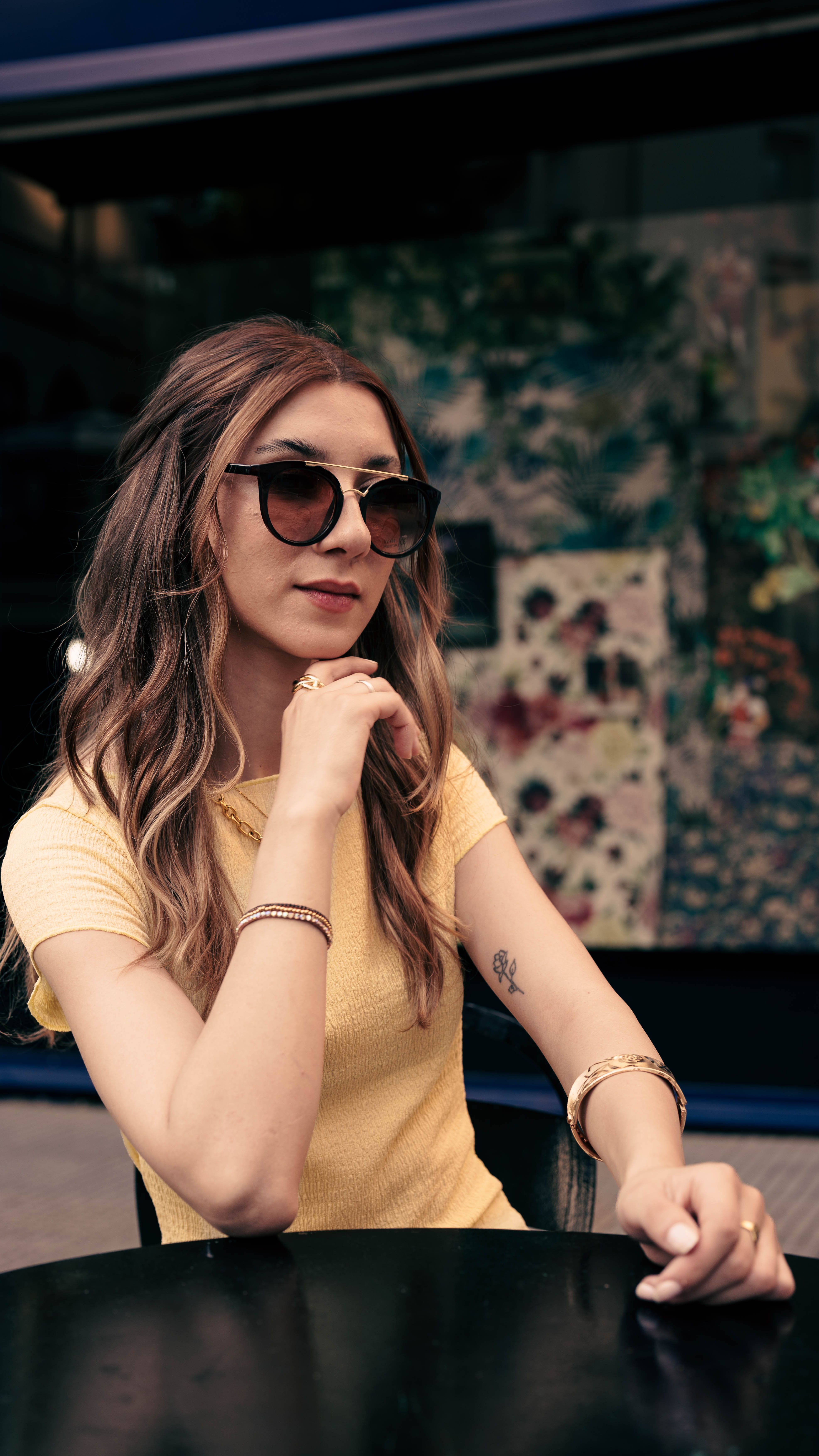 Stylish Woman Posing Outdoors in Sunglasses · Free Stock Photo