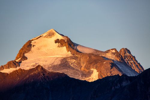 Free Stunning view of a snow-capped mountain summit in Auvergne-Rhône-Alpes, France at sunset. Stock Photo