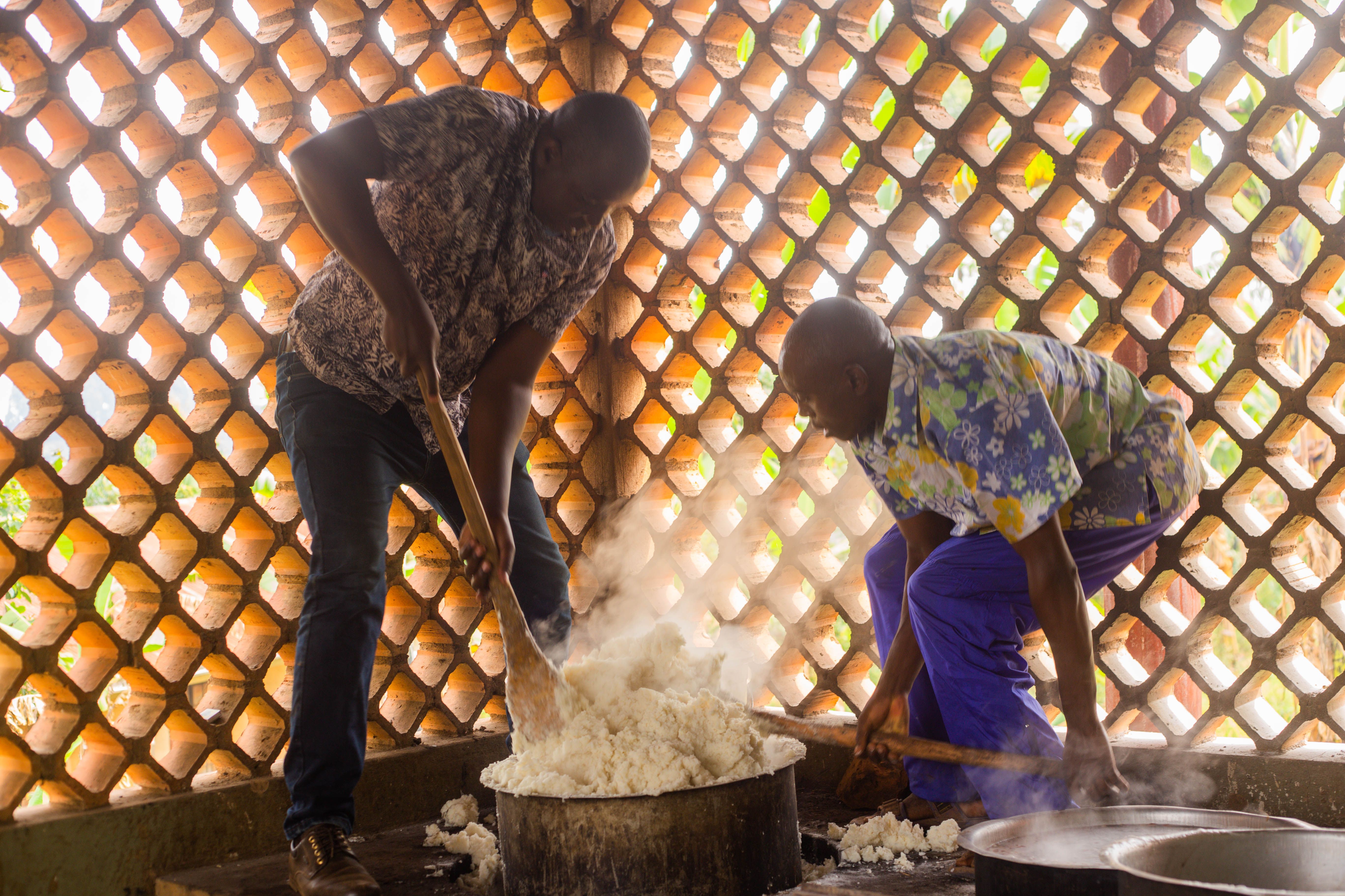 African chefs cooking traditional meal in rustic kitchen · Free Stock Photo