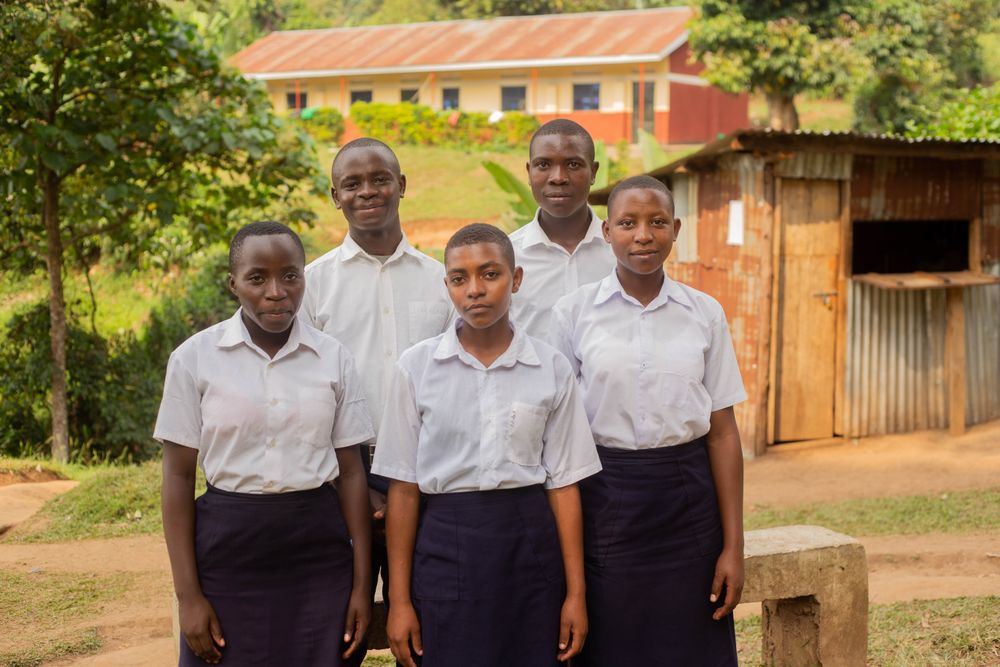 Students posing outside a school building