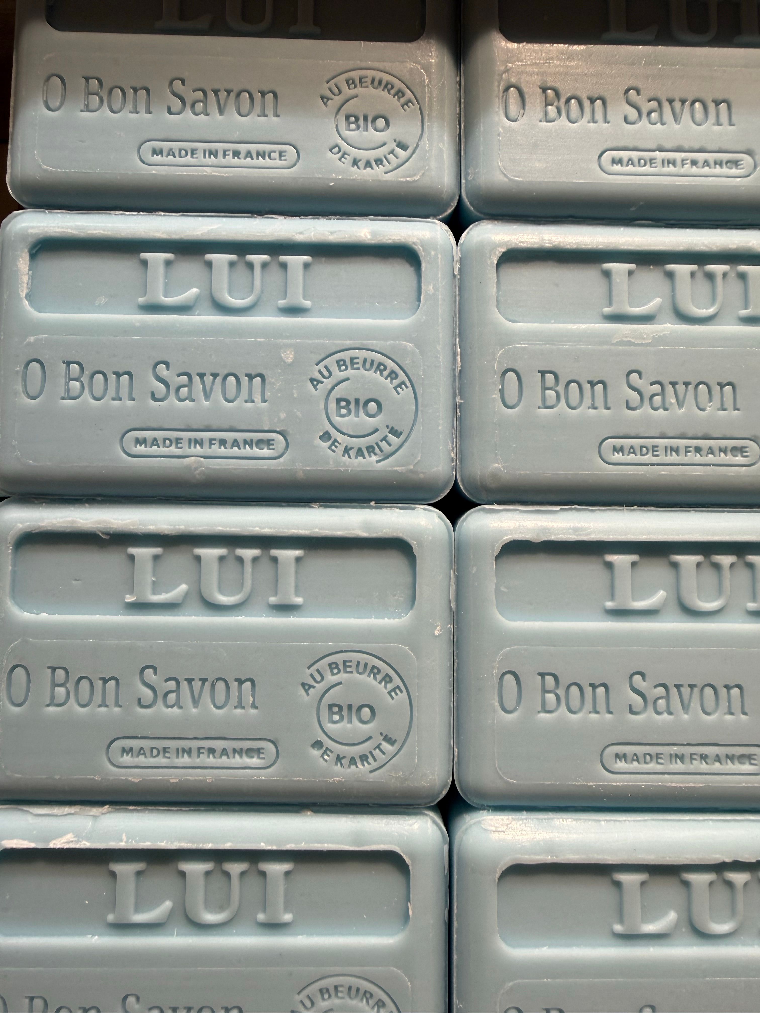 Close-up of stacked organic soap bars labeled 'O Bon Savon' made in France.