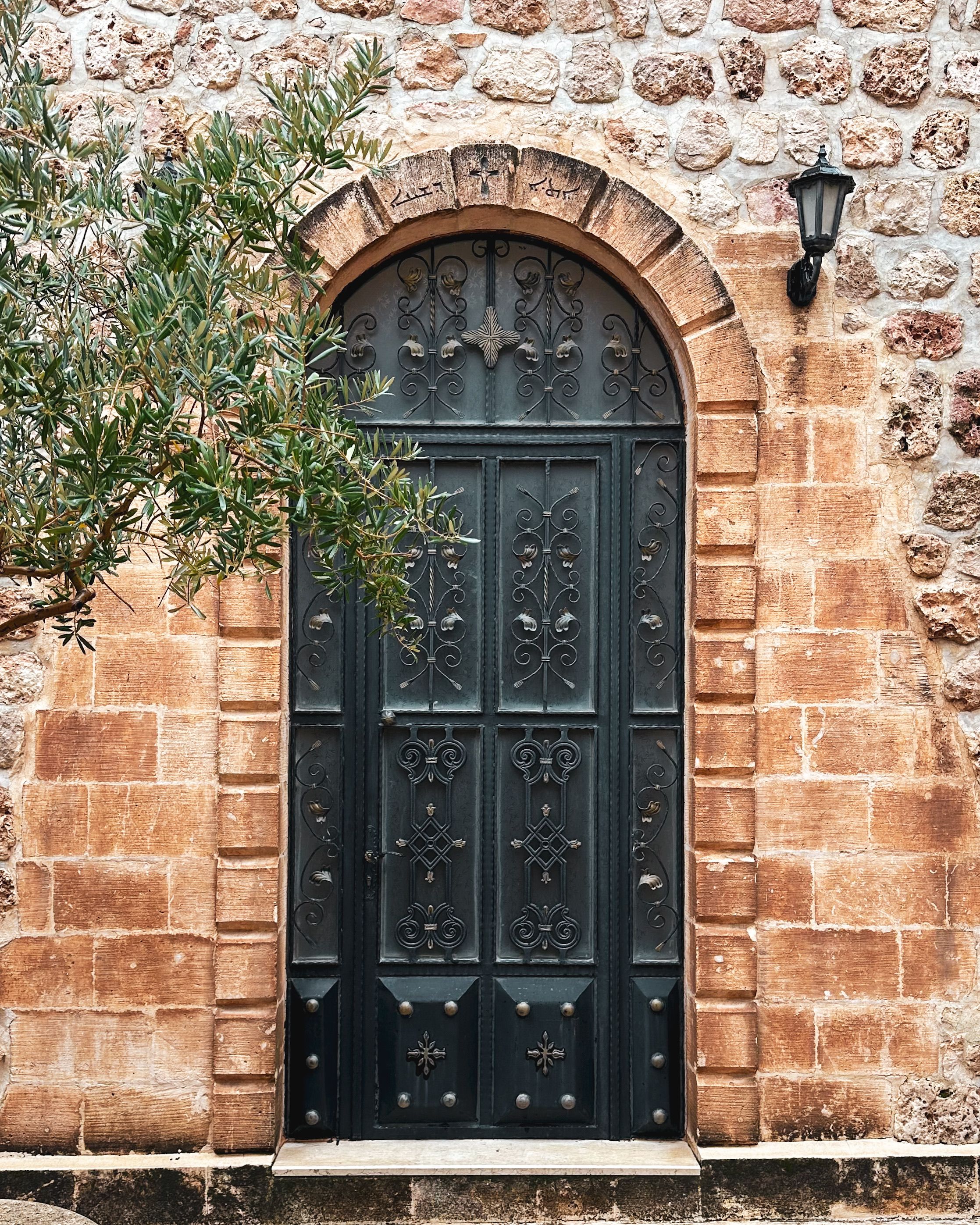 Historic Stone Building with Ornate Iron Door · Free Stock Photo