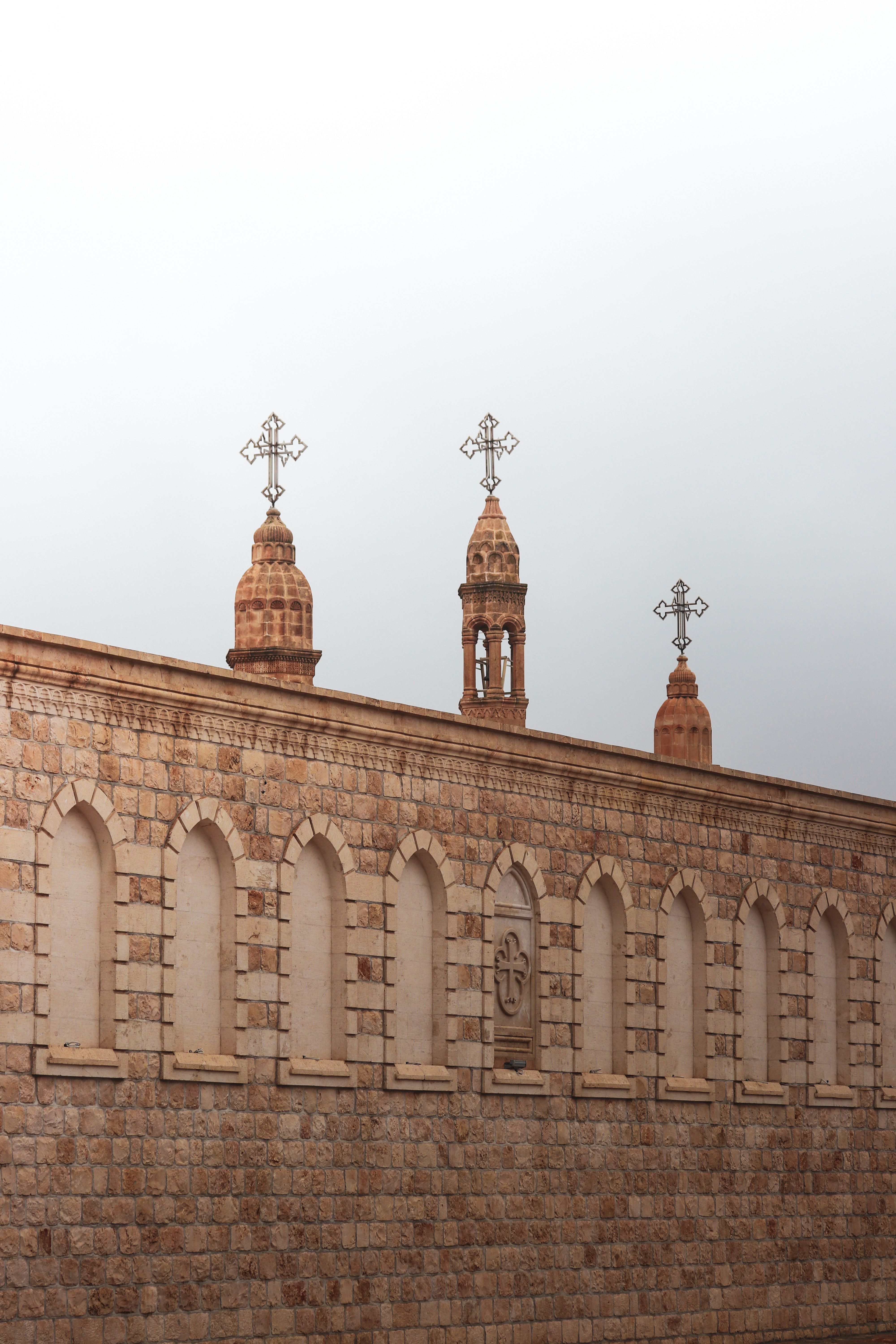 Historic Stone Church with Crosses on Roof · Free Stock Photo