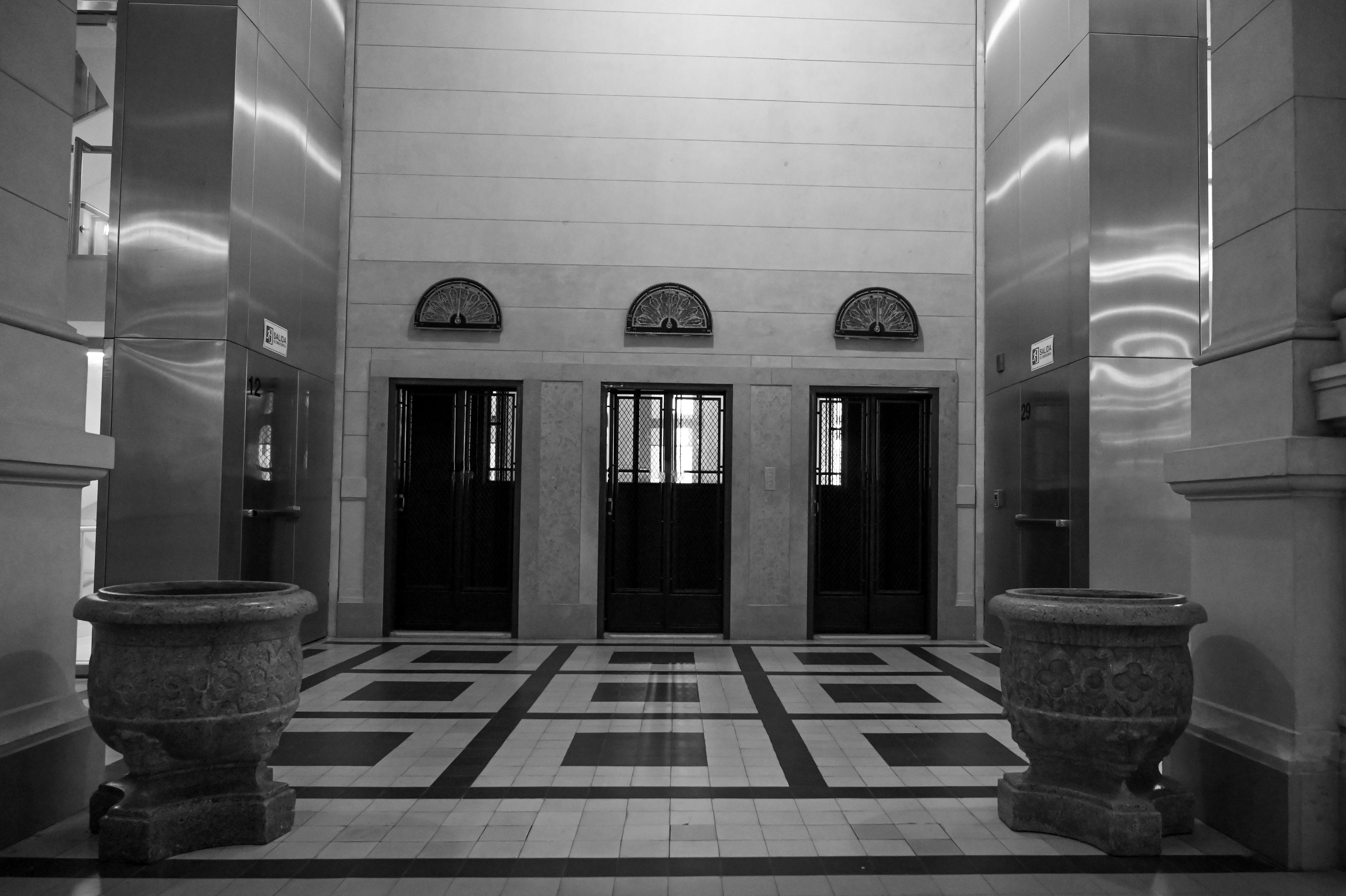 Sophisticated view of an Art Deco elevator lobby with geometric patterns and vintage charm.