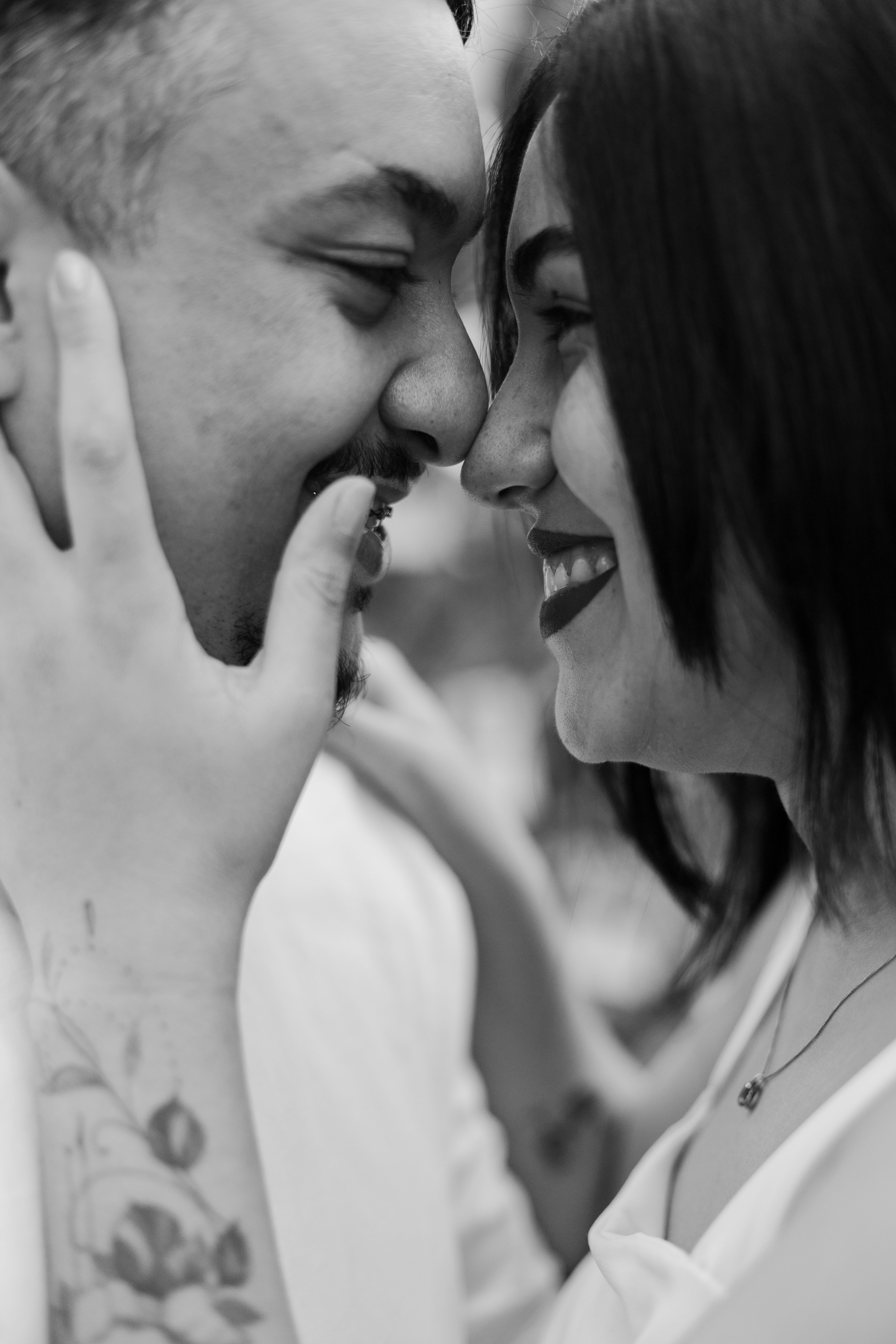Close-up black and white portrait of a happy couple sharing an intimate moment.