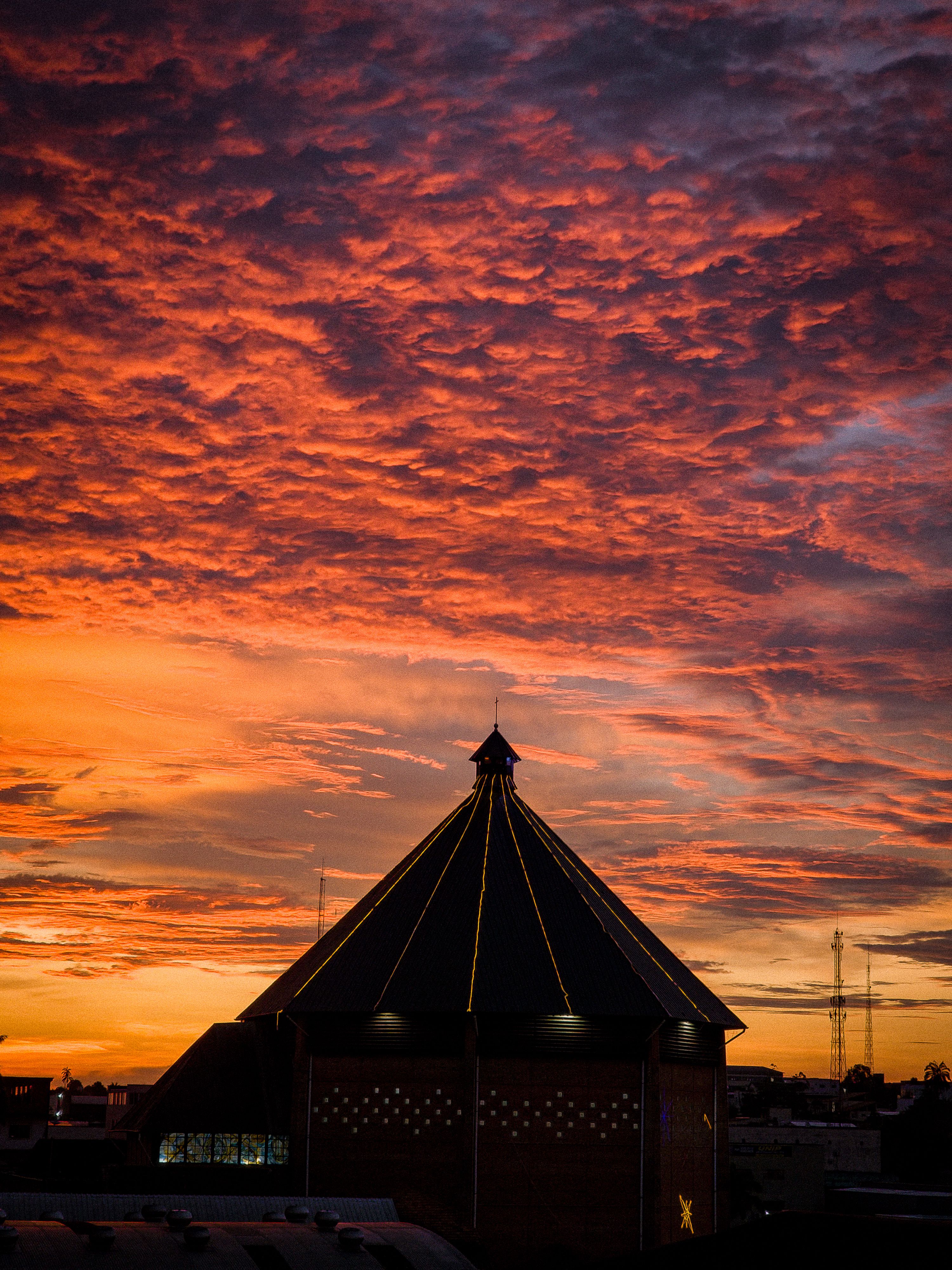 Stunning sunset with vibrant colors over a church in Cruzeiro do Sul, Brazil.