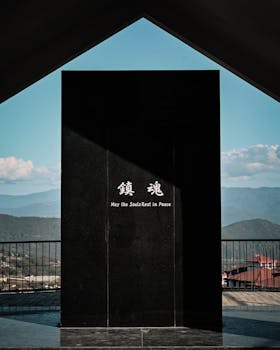 A solemn war memorial in Kohima, Nagaland, with a peaceful mountain backdrop, symbolizing remembrance.