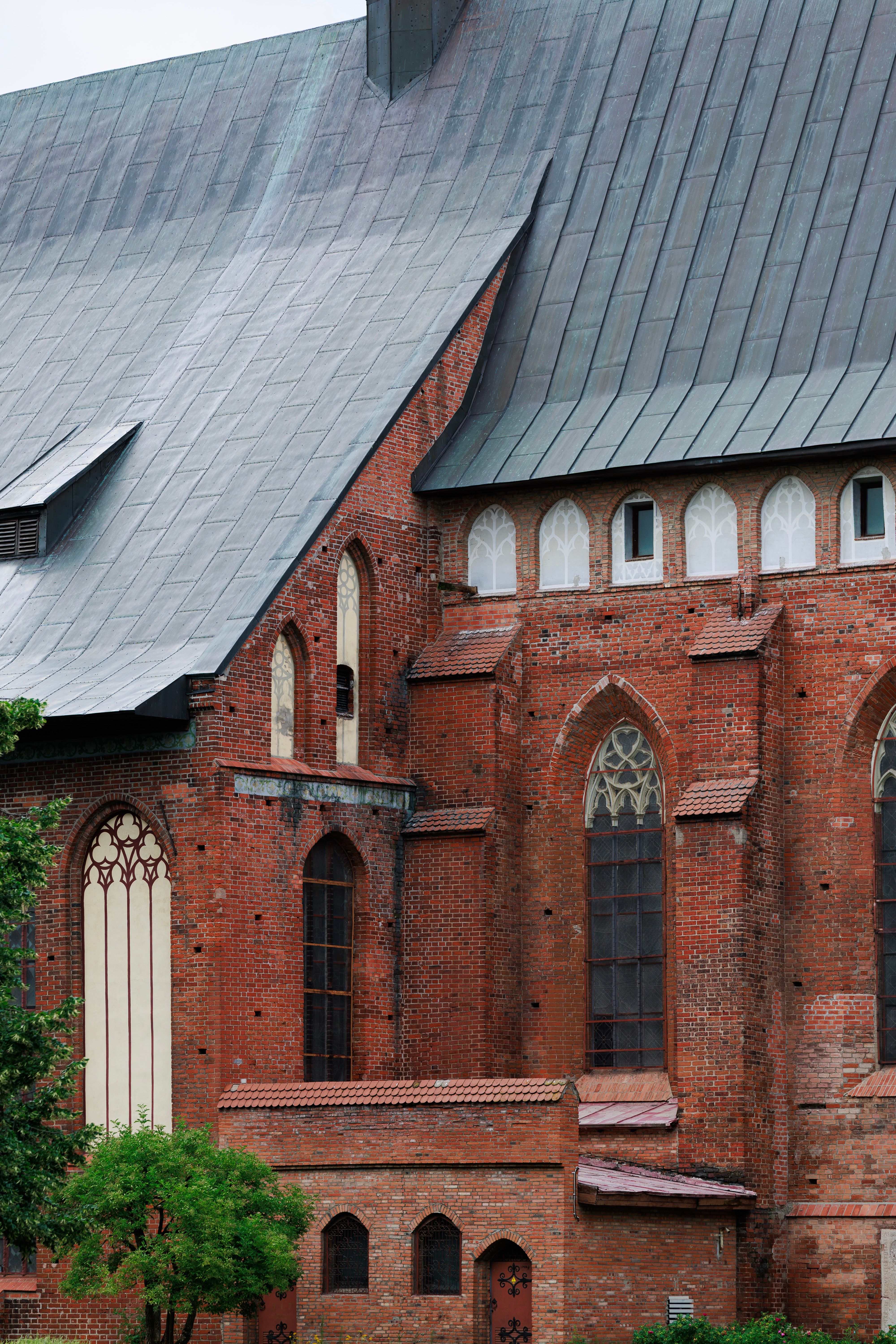 Historic Red Brick Church with Gothic Architecture · Free Stock Photo