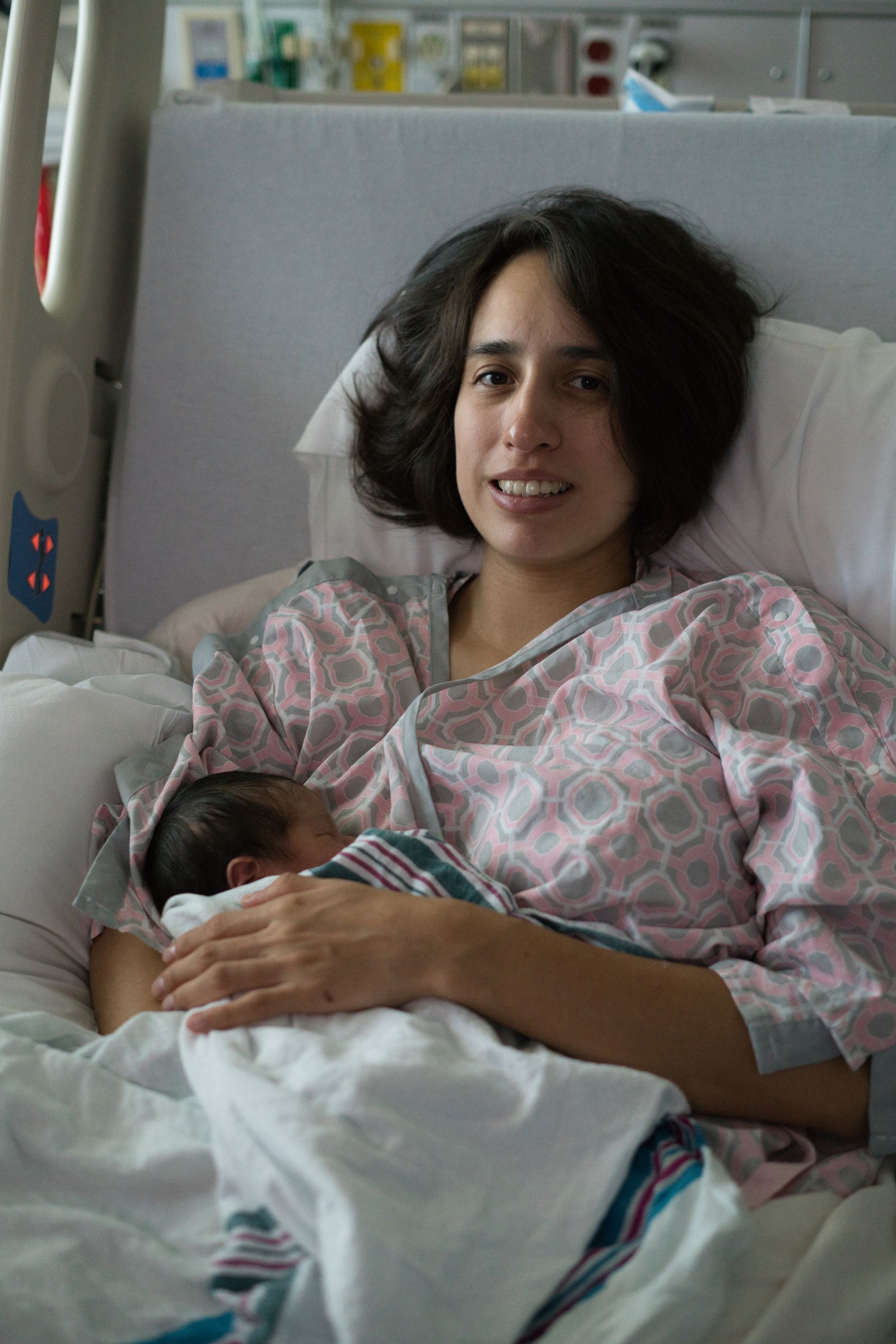 A postpartum doula providing warm, hands-on support to a new mother and her newborn at home during the fourth trimester — DNT Network postpartum doula certification training