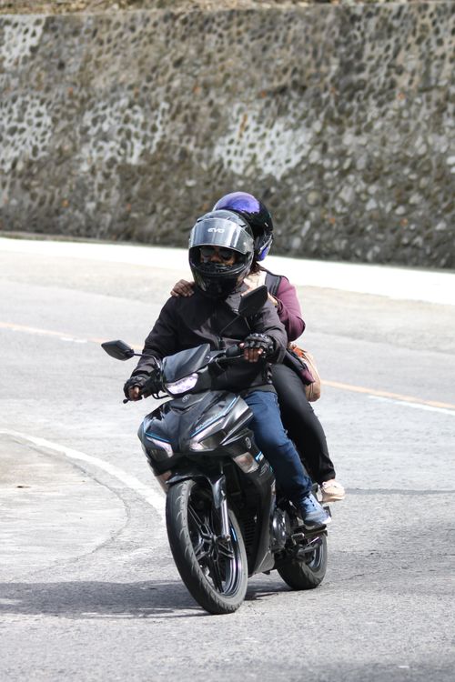 Free Dynamic action shot of two motorcyclists riding on a curved road, showcasing outdoor adventure. Stock Photo