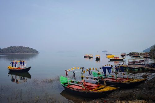 Free A serene view of decorated boats floating on the calm waters of Maithon Lake in Jharkhand, India. Stock Photo