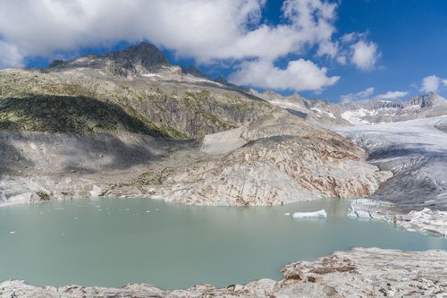 Free Captivating landscape of the Rhône Glacier and serene turquoise lake in Swiss Alps. Stock Photo