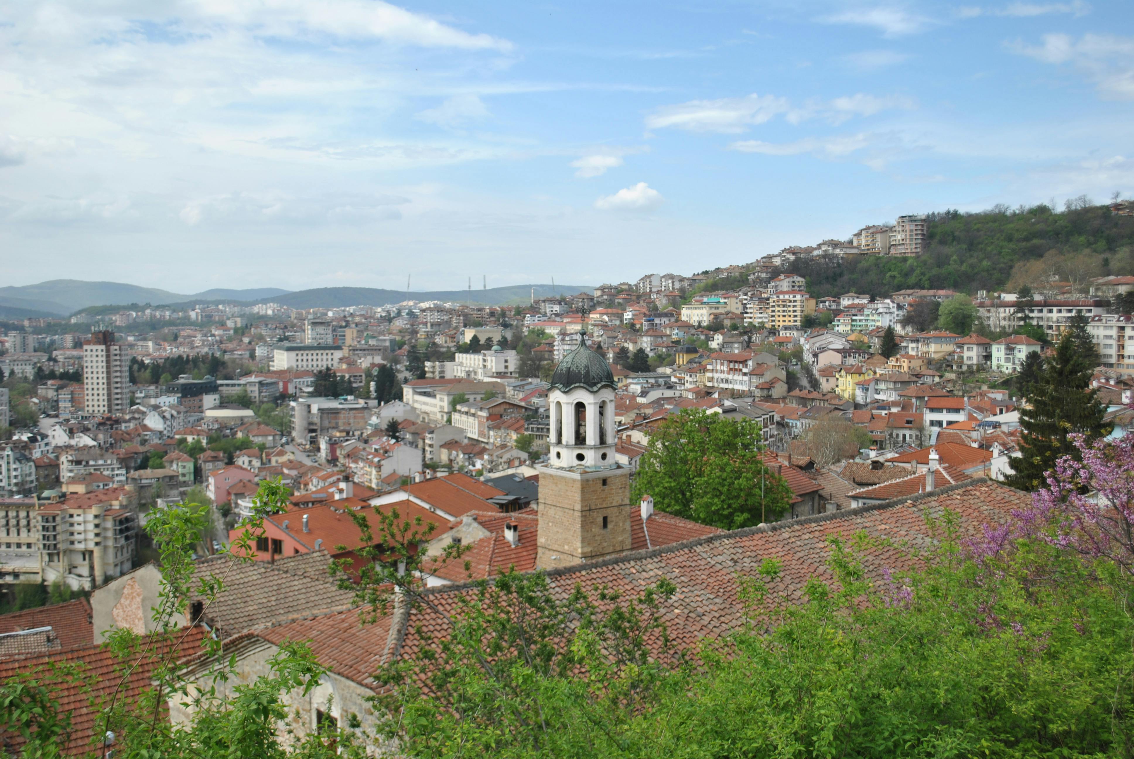 scenic view of Ho town from a hilltop with green vegetation and red-roofed buildings