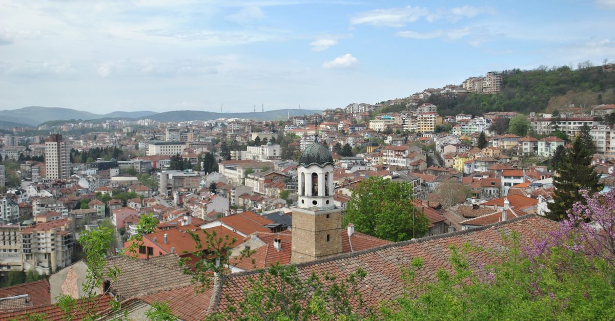 scenic view of Ho town from a hilltop with green vegetation and red-roofed buildings