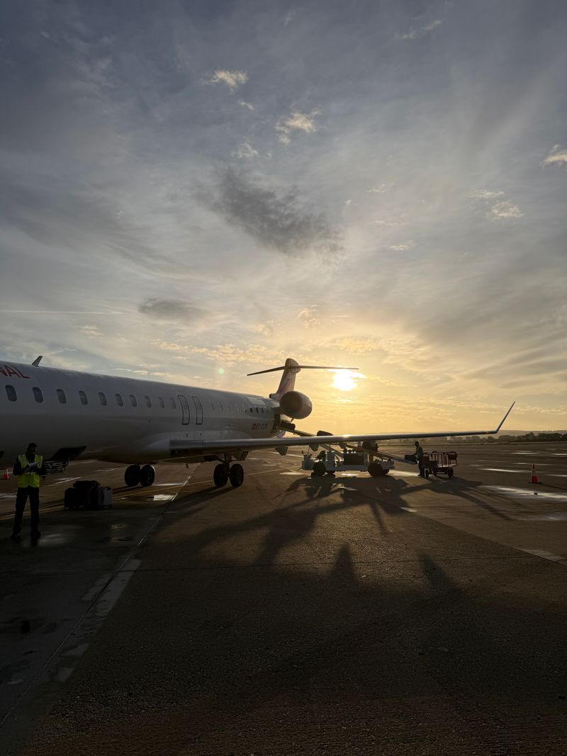Airplane on runway during sunset