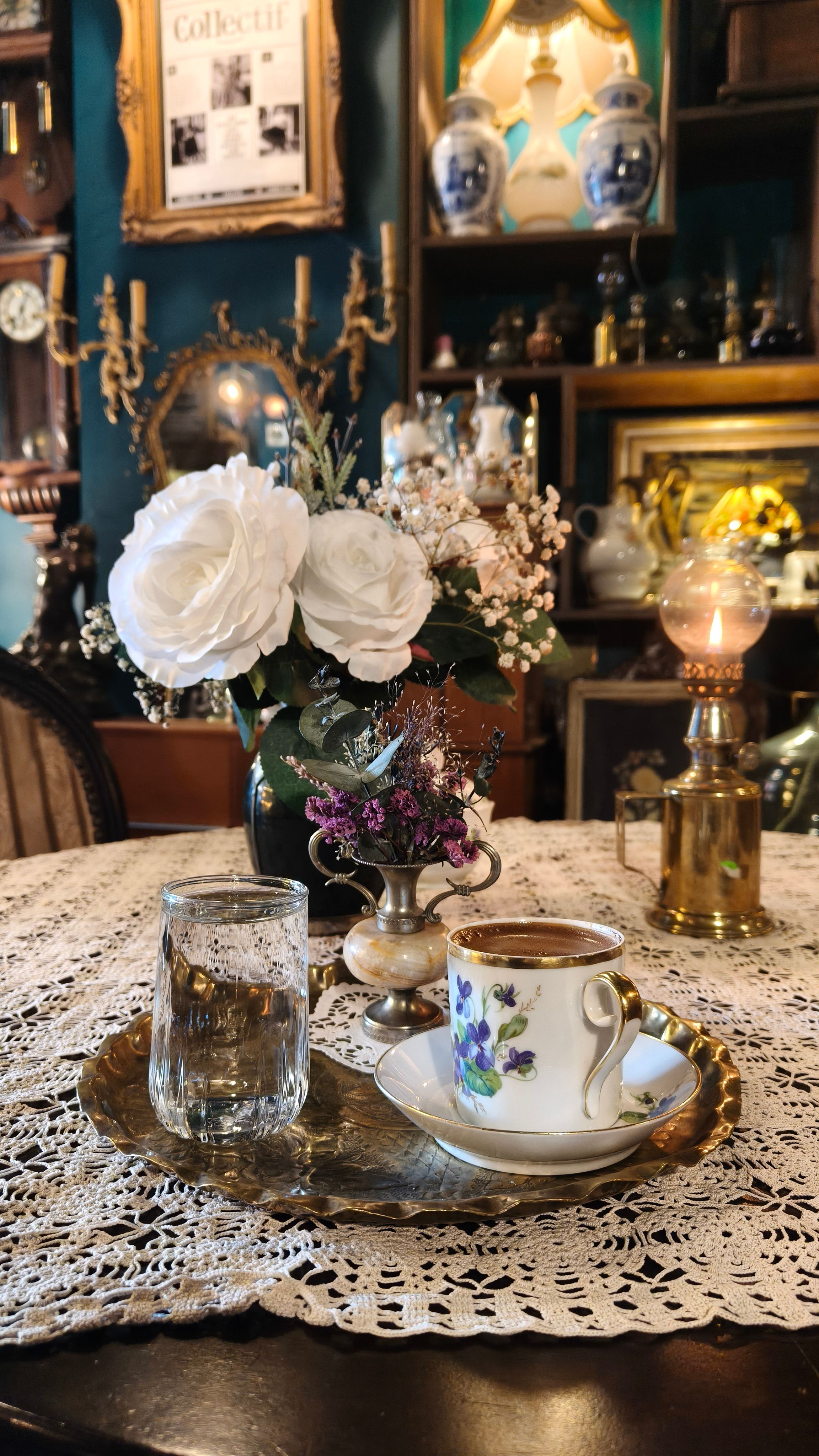Elegant vintage tea setting with flowers in an antique-styled room. Captures a nostalgic atmosphere.