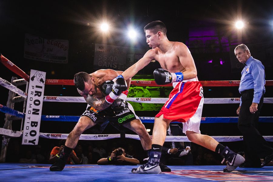 Boxers competing in a boxing ring